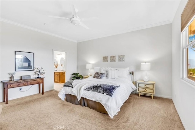 bedroom featuring crown molding, ensuite bathroom, light carpet, and a ceiling fan