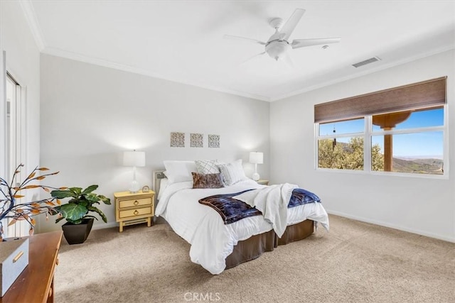 carpeted bedroom with crown molding, baseboards, ceiling fan, and visible vents