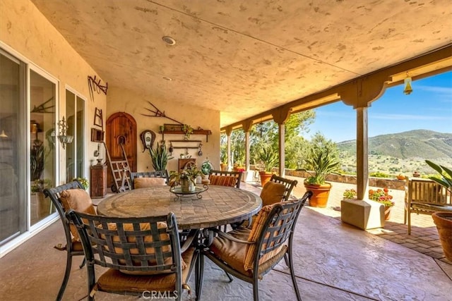 view of patio / terrace with a mountain view and outdoor dining area