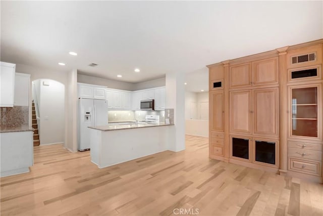5 Chinaberry, Irvine, CA 92618 - kitchen with stainless steel microwave, white fridge with ice dispenser, tasteful backsplash, recessed lighting, and arched walkways