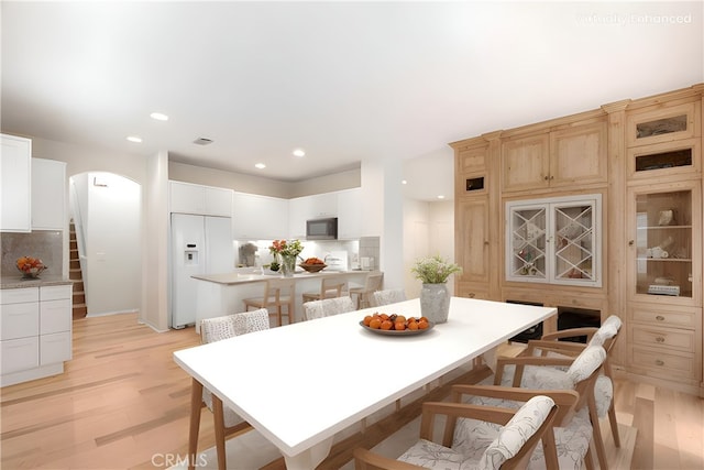 5 Chinaberry, Irvine, CA 92618 - dining space with arched walkways, light wood-style floors, recessed lighting, and stairs