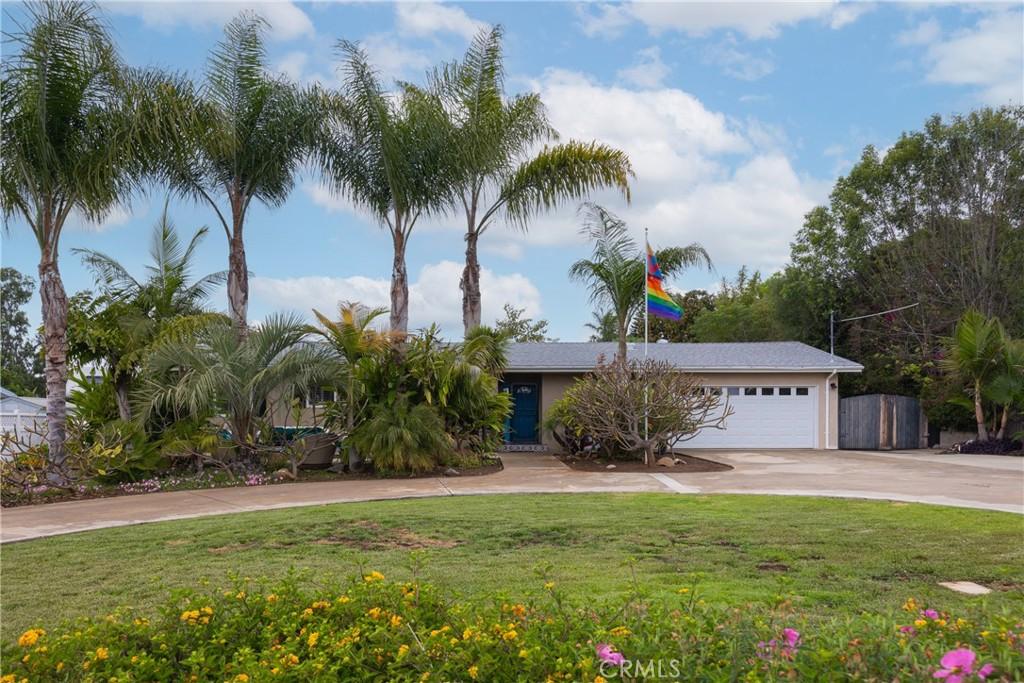 view of front of property with driveway, a front lawn, and an attached garage