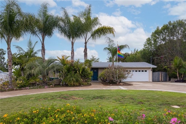 view of front of property with driveway, a front lawn, and an attached garage