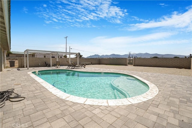 6748 Coriander Dr, Oak Hills, CA 92344 - view of swimming pool with a fenced backyard, a patio area, and a mountain view