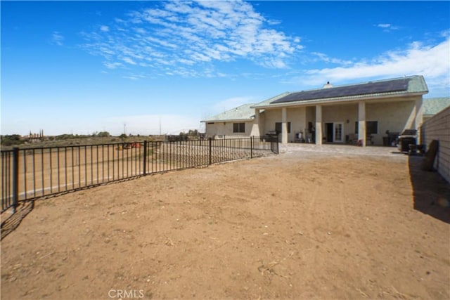 6748 Coriander Dr, Oak Hills, CA 92344 - rear view of property featuring a fenced backyard, a patio area, and solar panels
