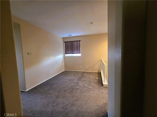 1480 Bedford Ct, Beaumont, CA 92223 - spare room featuring dark colored carpet and baseboards
