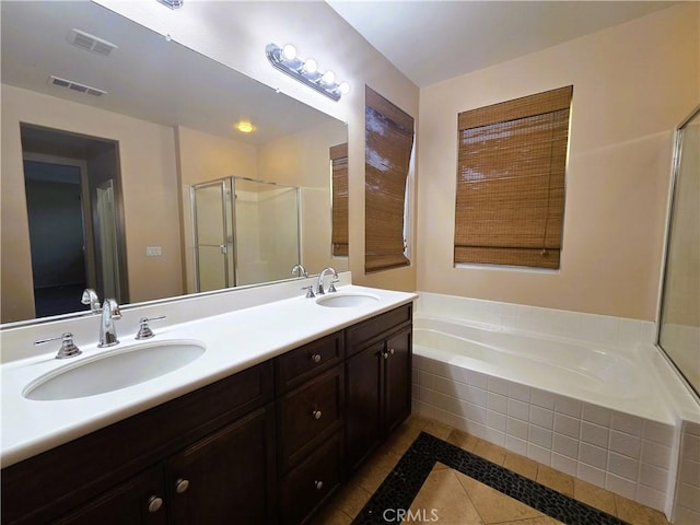 1480 Bedford Ct, Beaumont, CA 92223 - bathroom featuring tile patterned floors, a stall shower, a garden tub, double vanity, and inlaid floor details