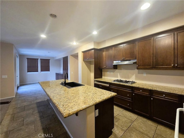 1480 Bedford Ct, Beaumont, CA 92223 - kitchen with a sink, stainless steel gas stovetop, light stone countertops, dark brown cabinetry, and recessed lighting