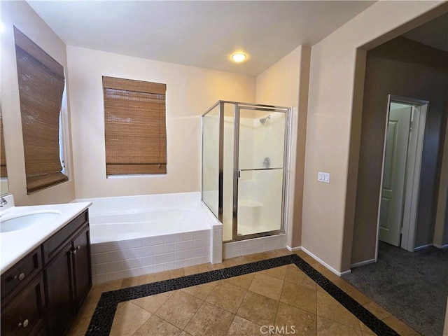 1480 Bedford Ct, Beaumont, CA 92223 - full bath featuring a shower stall, a garden tub, vanity, baseboards, and inlaid floor details