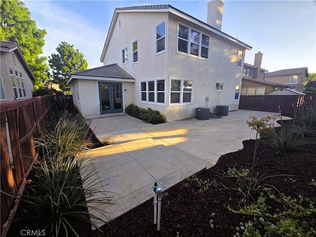 1480 Bedford Ct, Beaumont, CA 92223 - rear view of house featuring a patio area, a chimney, stucco siding, and a fenced backyard