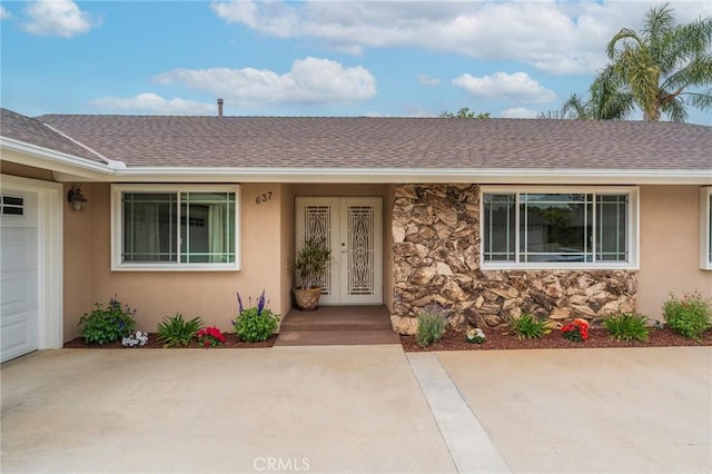 637 Anson St, Simi Valley, CA 93065 - view of front of property featuring a shingled roof, stone siding, and stucco siding