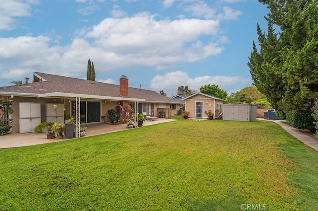 637 Anson St, Simi Valley, CA 93065 - rear view of house featuring a chimney, a lawn, and a patio area