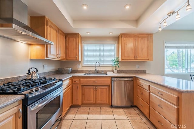 637 Anson St, Simi Valley, CA 93065 - kitchen featuring stainless steel appliances, wall chimney exhaust hood, a sink, a peninsula, and light tile patterned floors