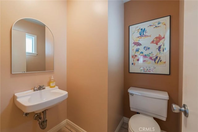 637 Anson St, Simi Valley, CA 93065 - half bathroom featuring toilet, baseboards, and a sink