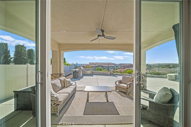 view of patio / terrace with an outdoor living space and ceiling fan