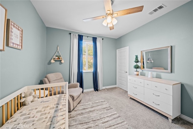 bedroom featuring light carpet, baseboards, and ceiling fan