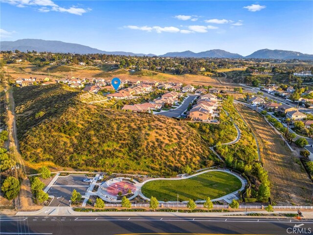 aerial view of property's location with mountains and nearby suburban area