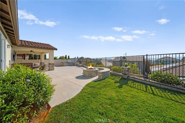 view of yard with a fire pit, a patio area, and ceiling fan