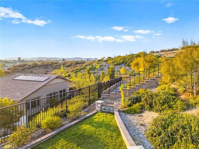 view of yard featuring fence and a mountain view