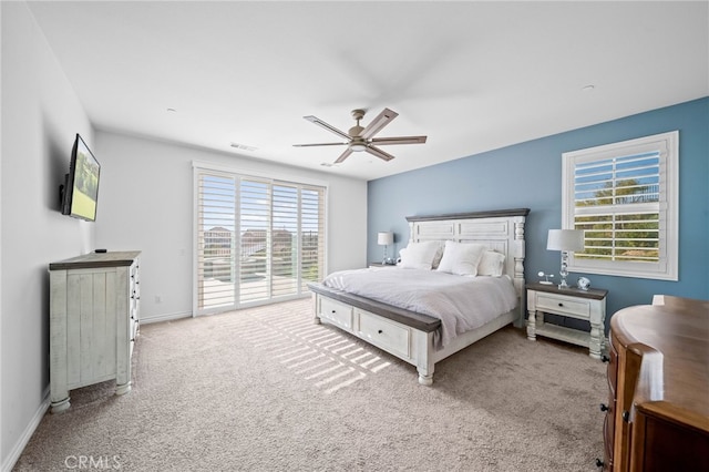 carpeted bedroom with access to exterior, multiple windows, baseboards, and ceiling fan