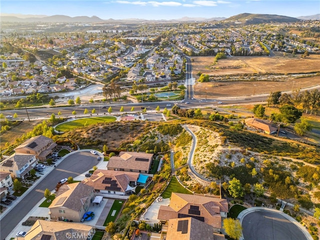 aerial view of property and surrounding area featuring nearby suburban area and mountains