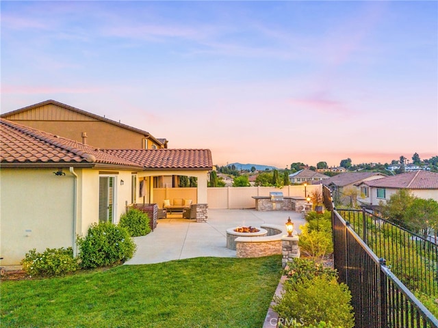 view of yard featuring an outdoor living space with a fire pit and a patio