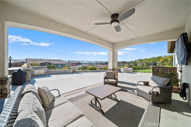 40571 Alder Ct, Temecula, CA 92591 - view of patio with exterior kitchen, an outdoor hangout area, fence, and a ceiling fan