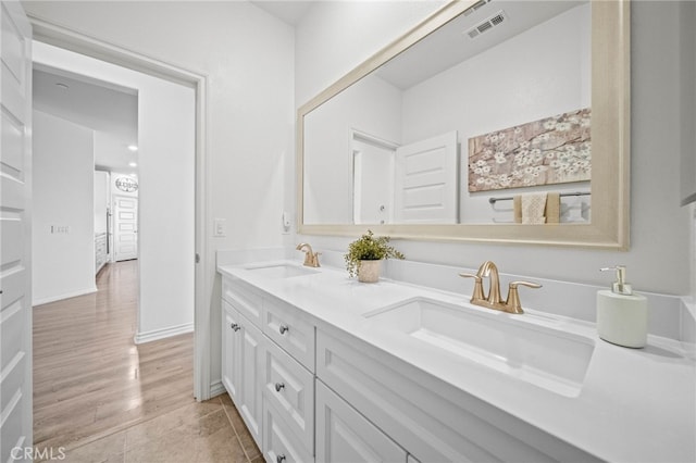 bathroom featuring double vanity and wood finished floors