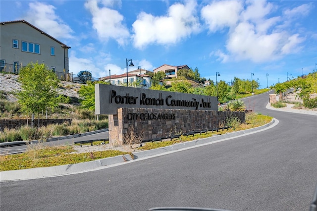 community sign featuring fence