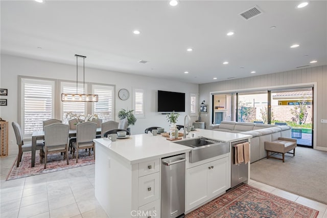 kitchen featuring recessed lighting, light tile patterned floors, visible vents, a sink, and open floor plan