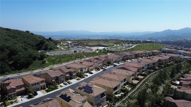 drone / aerial view featuring a residential view and a mountain view