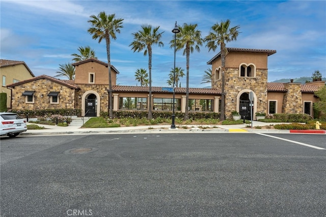 view of building exterior featuring uncovered parking