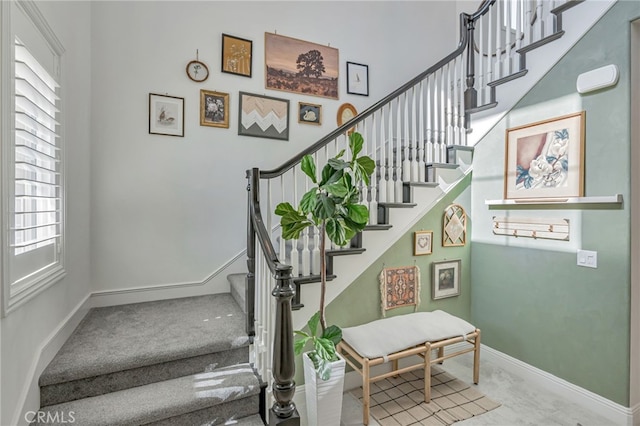 staircase featuring baseboards