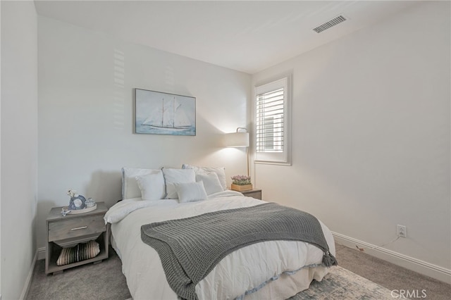 carpeted bedroom with visible vents and baseboards