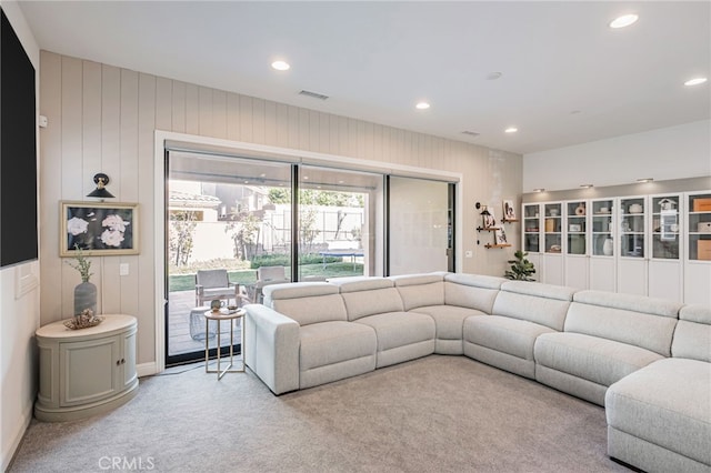 living area with carpet flooring, visible vents, and recessed lighting