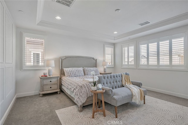bedroom featuring a tray ceiling, light carpet, baseboards, and visible vents