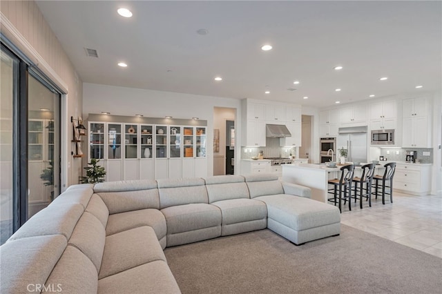 living room featuring light tile patterned floors, visible vents, and recessed lighting