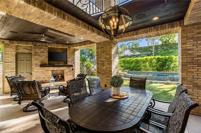 11 Sunswept Mesa, Aliso Viejo, CA 92656 - view of patio featuring an outdoor stone fireplace, a ceiling fan, outdoor dining area, and an outdoor pool