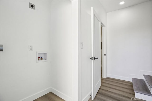 clothes washing area with wood finished floors, electric dryer hookup, baseboards, and hookup for a washing machine