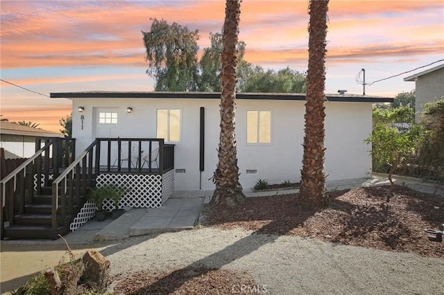 view of front of property featuring stucco siding and crawl space