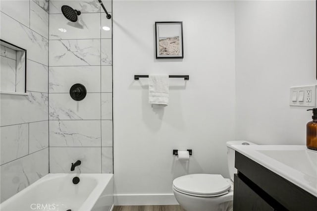 bathroom featuring toilet, baseboards, vanity, tub / shower combination, and wood finished floors