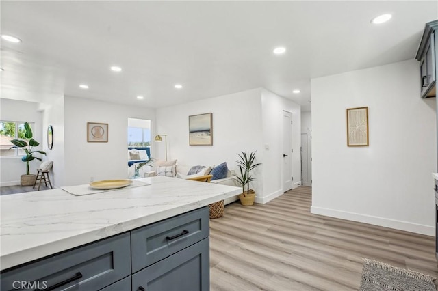 kitchen featuring light wood finished floors, open floor plan, a healthy amount of sunlight, and recessed lighting