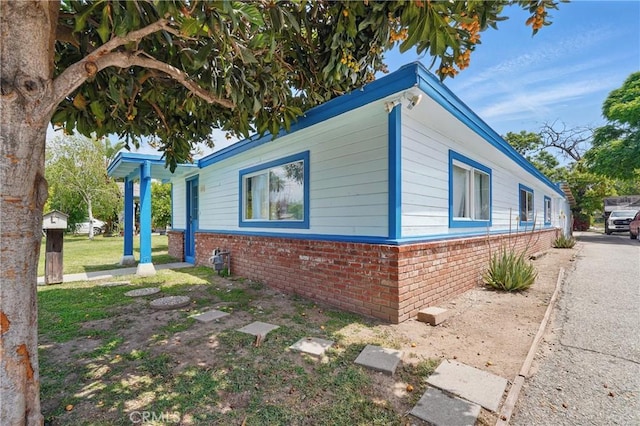 view of side of home with brick siding