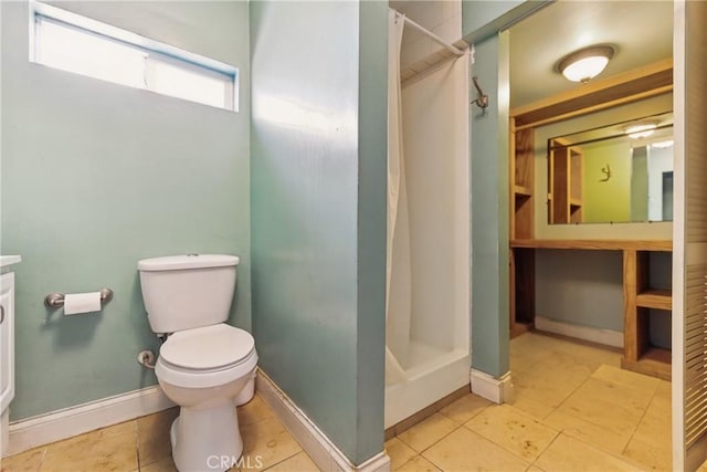 full bathroom featuring toilet, vanity, tile patterned floors, a shower stall, and baseboards