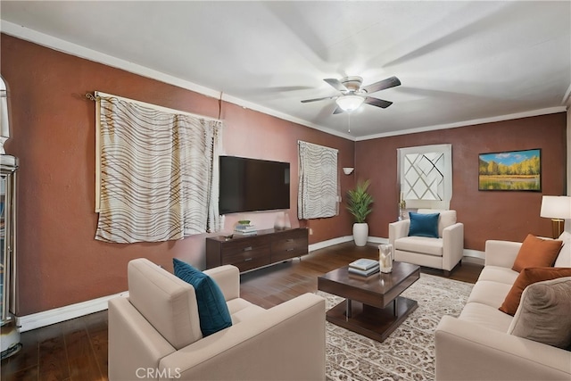 living room with baseboards, ceiling fan, and wood finished floors