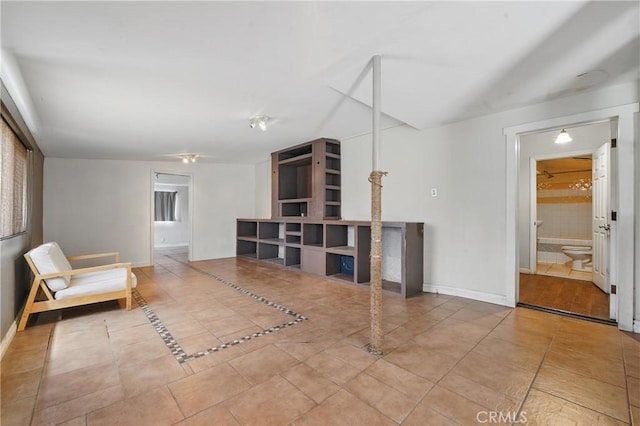 living area featuring tile patterned floors and baseboards