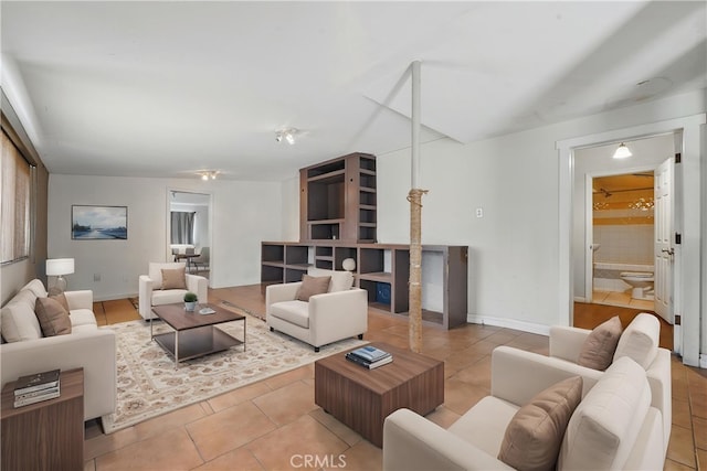 tiled living room featuring baseboards