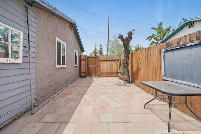 view of patio featuring a gate and fence