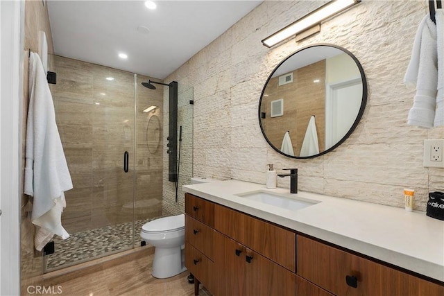 44 Corniche Dr Unit G, Dana Point, CA 92629 - bathroom with tile walls, toilet, a shower stall, vanity, and backsplash