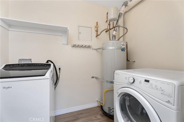 44 Corniche Dr Unit G, Dana Point, CA 92629 - laundry area with washer and dryer, water heater, wood finished floors, and baseboards
